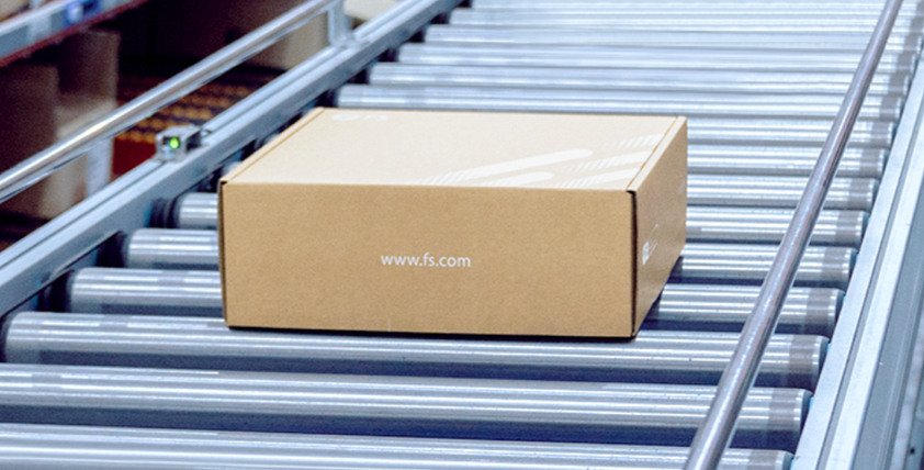The image shows a box on a conveyor belt in a warehous.